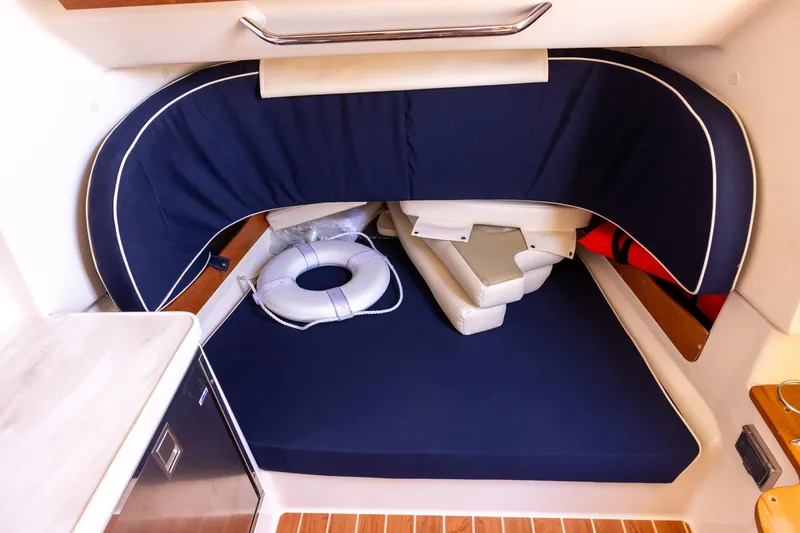 Slide: The Image of 2022 Grady-White Canyon 376 cabin interior with blue seating and life preserver. - 21
