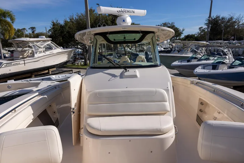 Slide: The Image of 2022 Grady-White Canyon 376 boat with Garmin equipment, docked among other boats. - 24