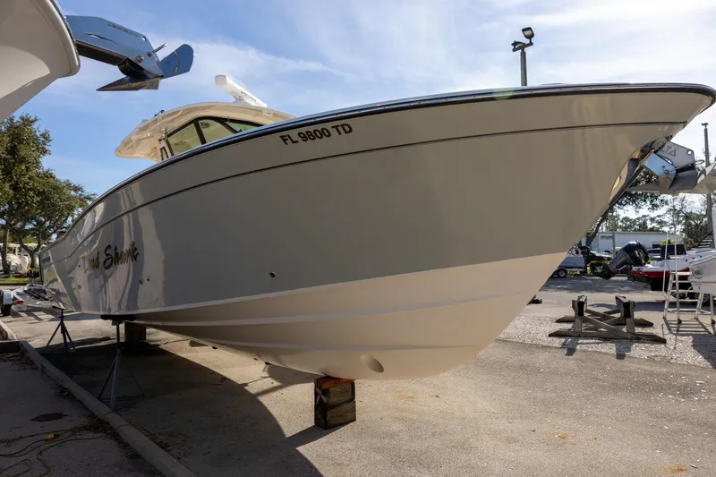 Slide: The Image of 2022 Grady-White Canyon 376 boat on display in a sunny outdoor setting. - 3