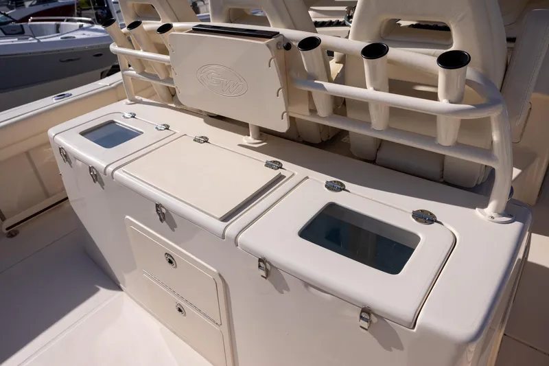 Slide: The Image of 2022 Grady-White Canyon 376 boat interior with storage compartments and rod holders. - 5