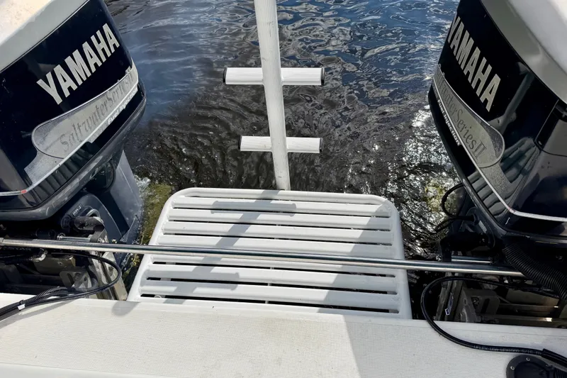 Slide: The Image of 2001 Cobra Predator 3100 boat with dual Yamaha outboard motors on water. - 14