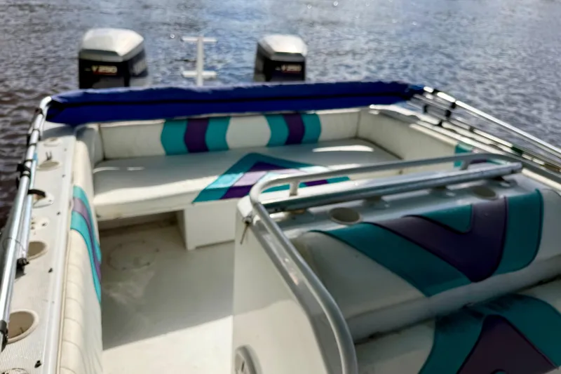 Slide: The Image of 2001 Cobra Predator 3100 boat interior with colorful seating and twin outboard motors. - 16