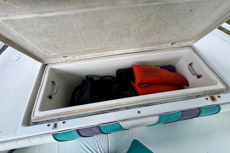 Slide: The Image of Open storage compartment on 2001 Cobra Predator 3100 boat with life jackets inside. - 17