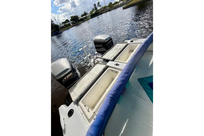 Slide: The Image of 2001 Cobra Predator 3100 boat with Yamaha V250 engines on a calm waterway. - 18