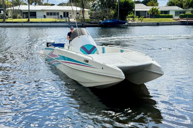 Slide: The Image of 2001 Cobra Predator 3100 boat cruising on a calm waterway. - 20