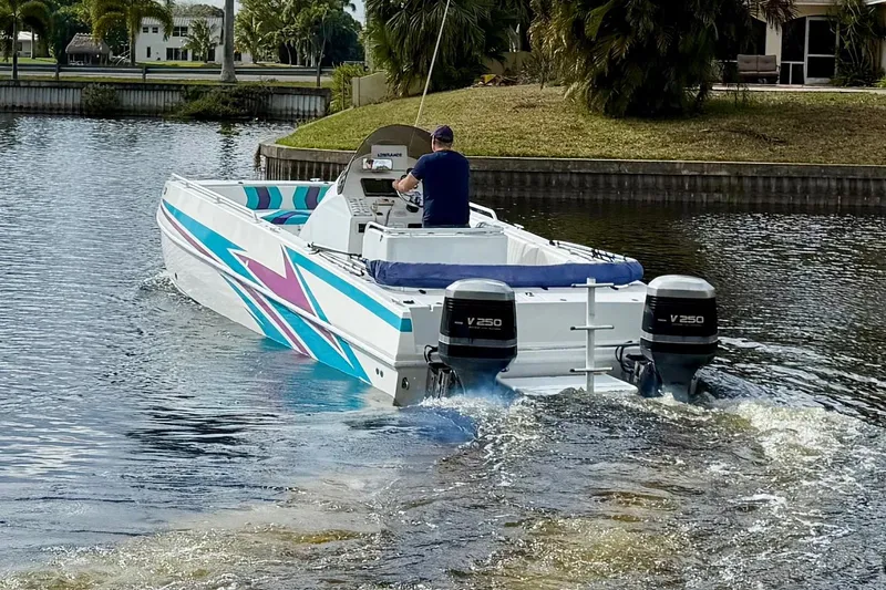 Slide: The Image of 2001 Cobra Predator 3100 boat cruising on a canal with twin V250 engines. - 26