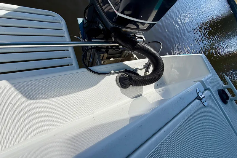 Slide: The Image of Rear deck view of 2001 Cobra Predator 3100 boat with motor and water reflection. - 30
