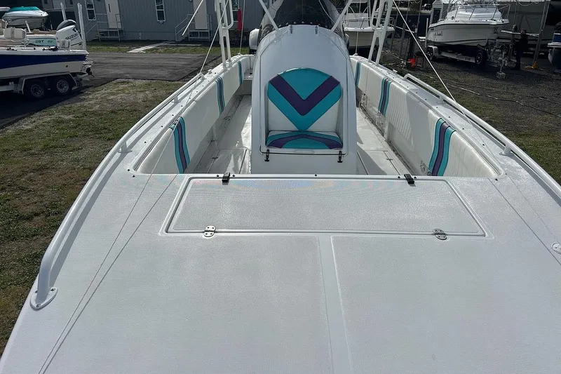 Slide: The Image of 2001 Cobra Predator 3100 boat with white deck and colorful seating. - 8