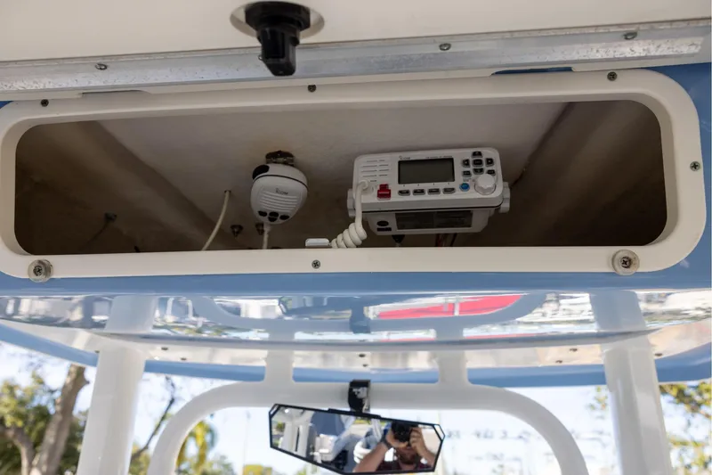 Slide: The Image of 2022 Robalo R242 Explorer boat electronics compartment with radio and speaker. - 17