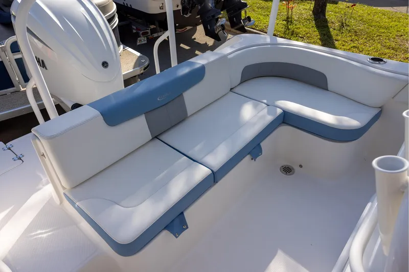 Slide: The Image of 2022 Robalo R242 Explorer boat seating area with white and blue cushions. - 18