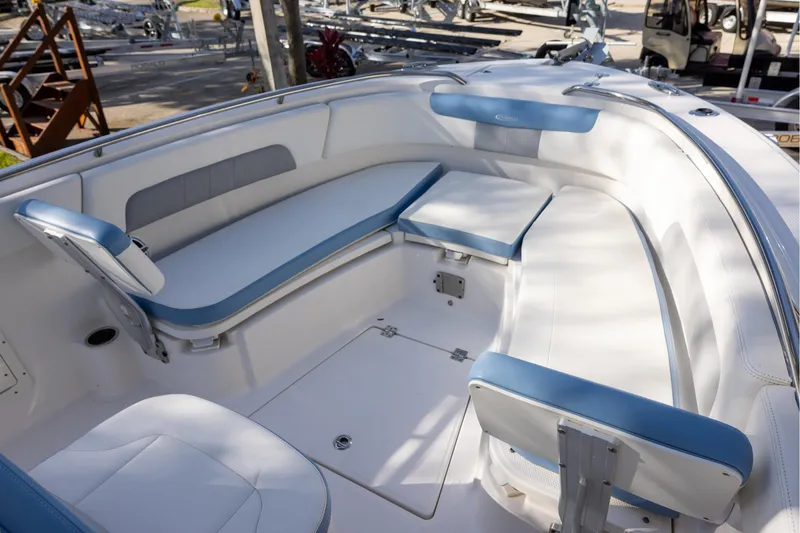 Slide: The Image of 2022 Robalo R242 Explorer boat interior with white and blue seating arrangement. - 19
