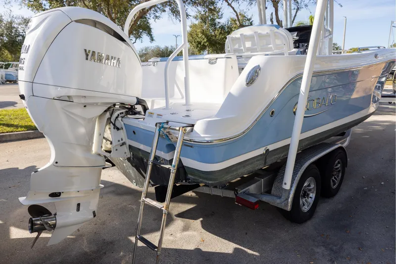 Slide: The Image of 2022 Robalo R242 Explorer boat with Yamaha engine on trailer, parked outdoors. - 3