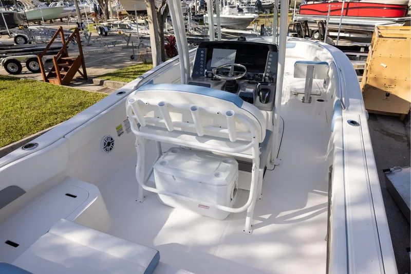 Slide: The Image of 2022 Robalo R242 Explorer boat interior with helm, seating, and storage. - 5