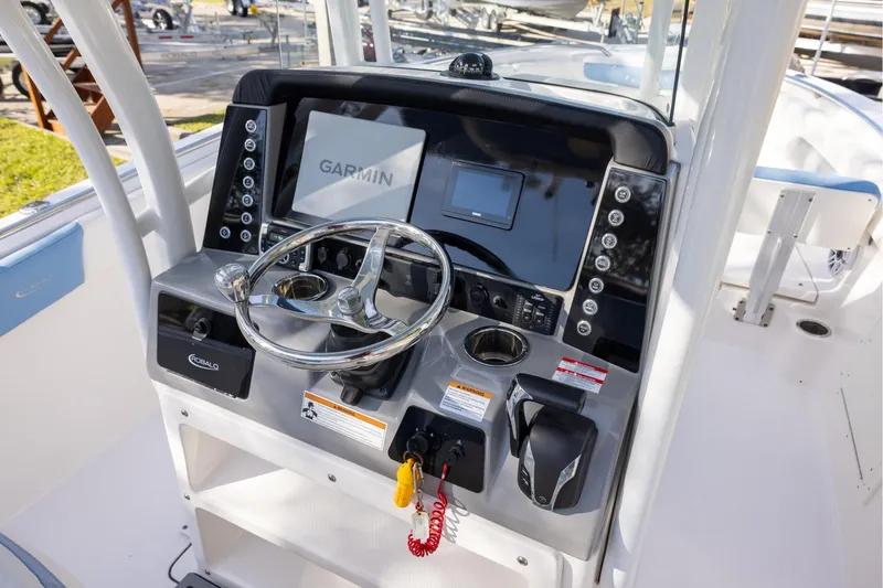 Slide: The Image of 2022 Robalo R242 Explorer helm with Garmin display and modern controls. - 9