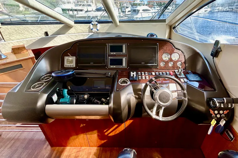 Slide: The Image of Cockpit of 2010 Sunseeker Predator 64 yacht with steering wheel and navigation controls. - 11