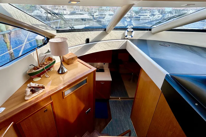 Slide: The Image of Interior of 2010 Sunseeker Predator 64 yacht with elegant wood finish and nautical decor. - 12