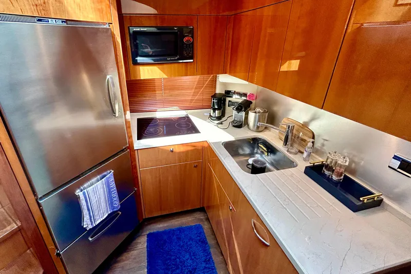 Slide: The Image of Luxurious kitchen in 2010 Sunseeker Predator 64 yacht with modern appliances and sleek design. - 14