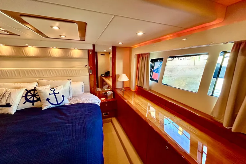 Slide: The Image of Luxurious 2010 Sunseeker Predator 64 yacht bedroom with nautical-themed decor. - 18