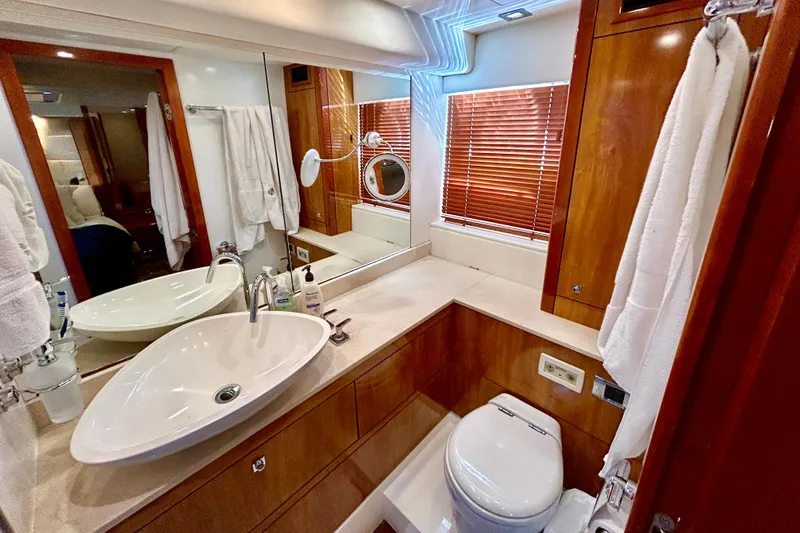Slide: The Image of Luxurious bathroom in 2010 Sunseeker Predator 64 yacht with modern fixtures and wooden accents. - 20
