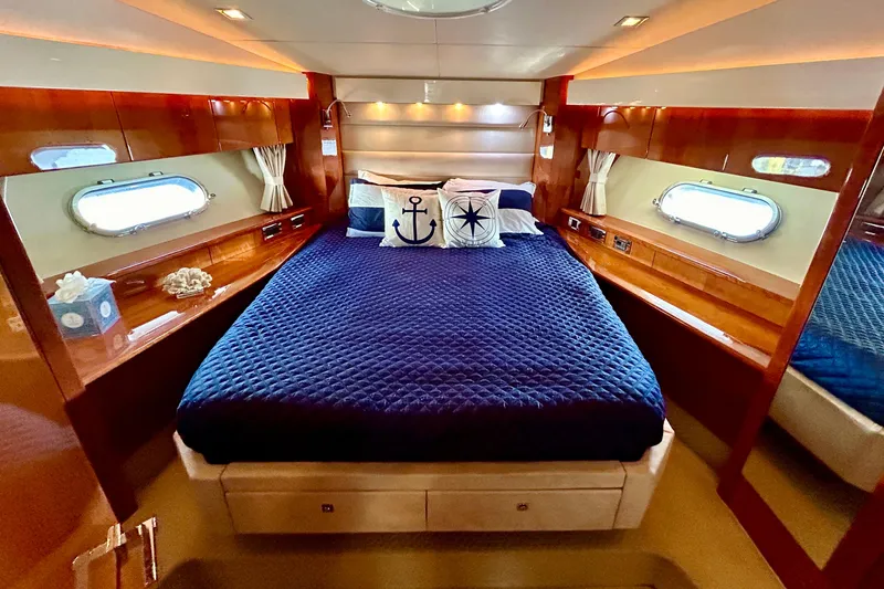 Slide: The Image of Luxurious cabin interior of 2010 Sunseeker Predator 64 yacht with nautical-themed bedding. - 21