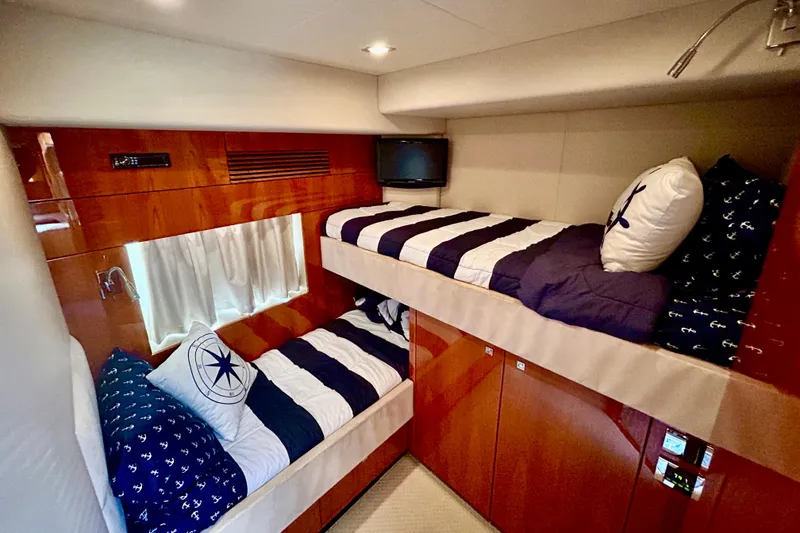 Slide: The Image of Bunk beds in 2010 Sunseeker Predator 64 yacht cabin with nautical-themed decor. - 23