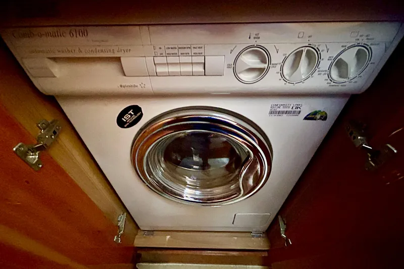 Slide: The Image of Washing machine inside 2010 Sunseeker Predator 64 yacht, featuring compact design and controls. - 24