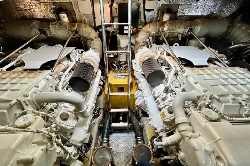 Slide: The Image of Engine room of 2010 Sunseeker Predator 64 yacht, showcasing dual engines and mechanical components. - 25