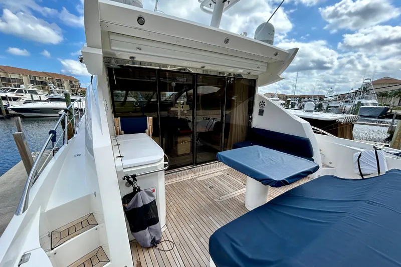 Slide: The Image of 2010 Sunseeker Predator 64 yacht with spacious deck and marina view. - 3