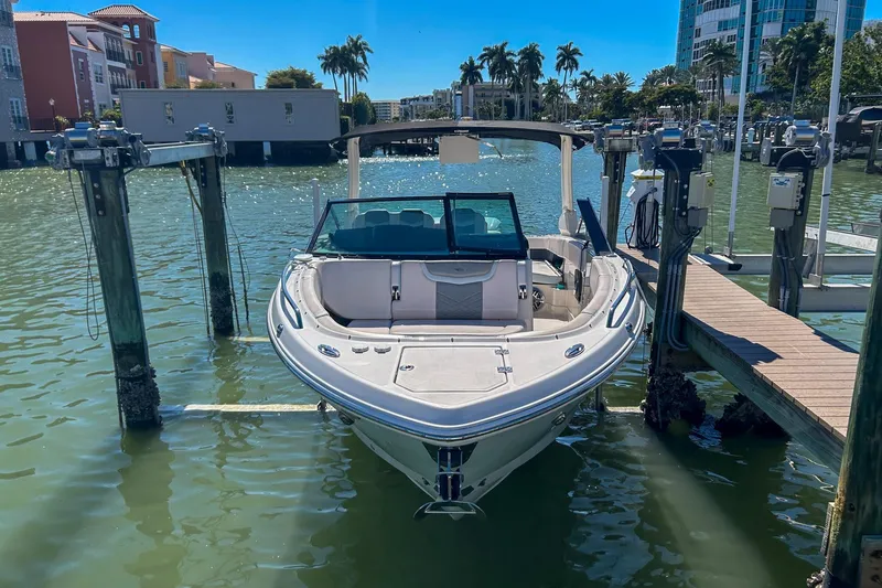 Slide: The Image of 2021 Chaparral 280 OSX boat docked in sunny marina with palm trees. - 11