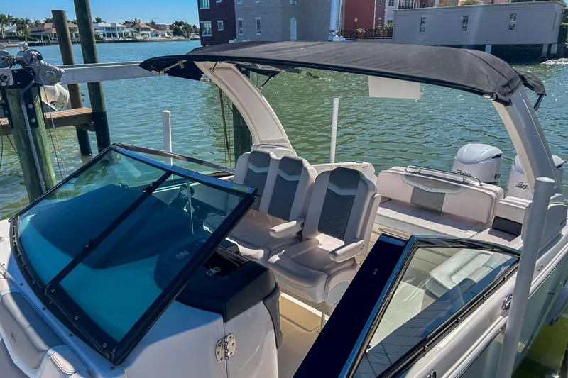 Slide: The Image of 2021 Chaparral 280 OSX boat with seating, canopy, and waterfront view. - 14