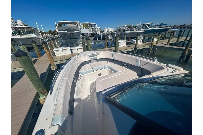 Slide: The Image of 2021 Chaparral 280 OSX boat docked at marina, showcasing spacious seating area. - 7