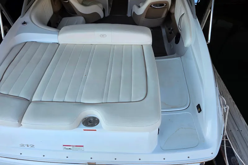 Slide: The Image of 2007 Cobalt 212 boat interior with white cushioned seating and sleek design. - 10