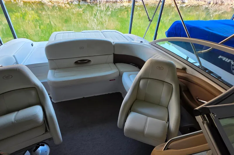 Slide: The Image of Interior of a 2007 Cobalt 212 boat with beige seating and lake view. - 14