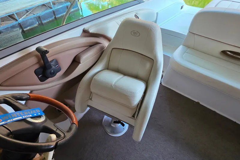 Slide: The Image of Interior of a 2007 Cobalt 212 boat featuring a white captain's chair and steering wheel. - 15