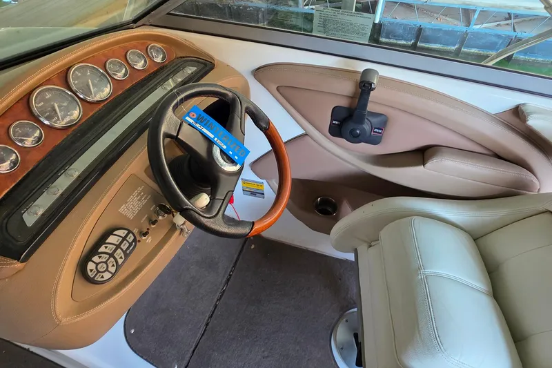 Slide: The Image of Interior of a 2007 Cobalt 212 boat showing steering wheel and dashboard controls. - 16