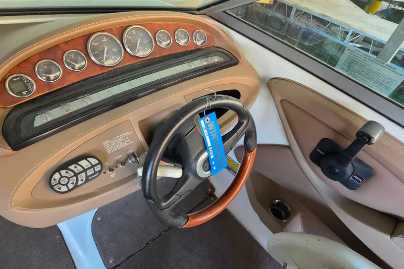 Slide: The Image of 2007 Cobalt 212 boat dashboard with gauges, steering wheel, and control panel. - 17