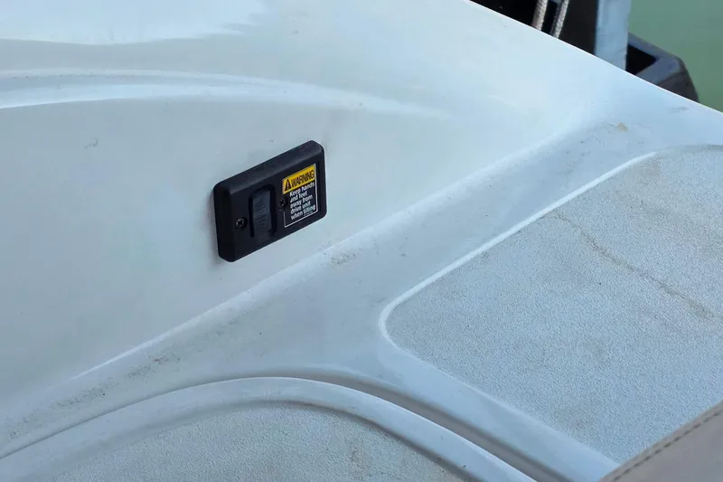 Slide: The Image of 2007 Cobalt 212 boat deck with warning label and textured surface. - 28