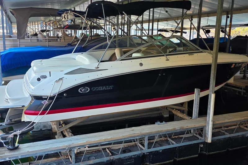 Slide: The Image of 2007 Cobalt 212 boat docked in covered marina, side view. - 3