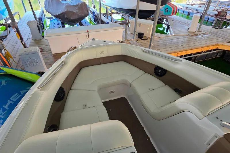 Slide: The Image of 2007 Cobalt 212 boat interior with spacious seating in a docked setting. - 31