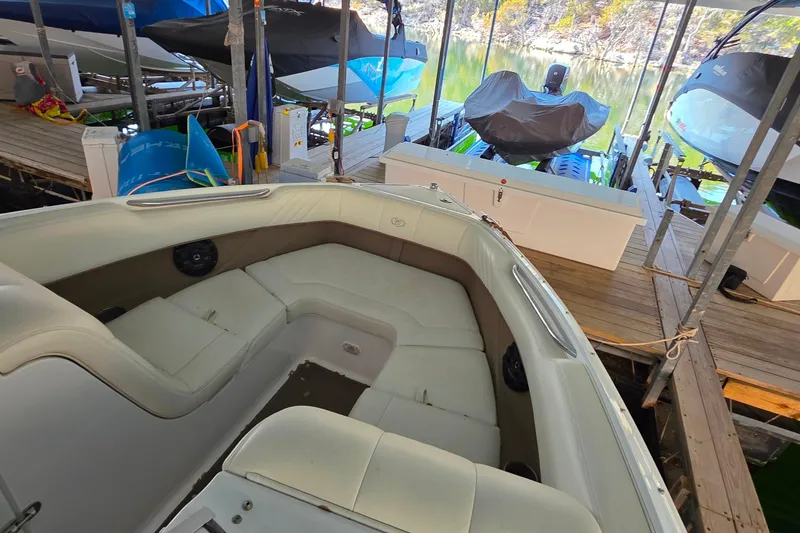 Slide: The Image of 2007 Cobalt 212 boat interior at dock, surrounded by other covered boats. - 32