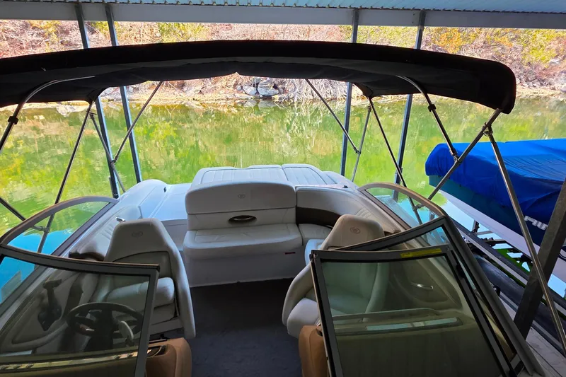 Slide: The Image of 2007 Cobalt 212 boat interior under canopy, docked by a serene lake. - 35