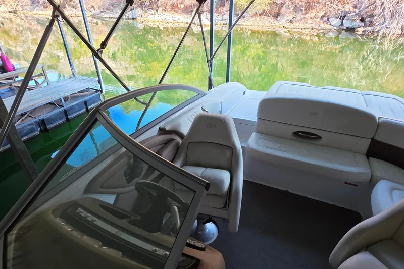 Slide: The Image of Interior of a 2007 Cobalt 212 boat docked by a serene lake. - 36