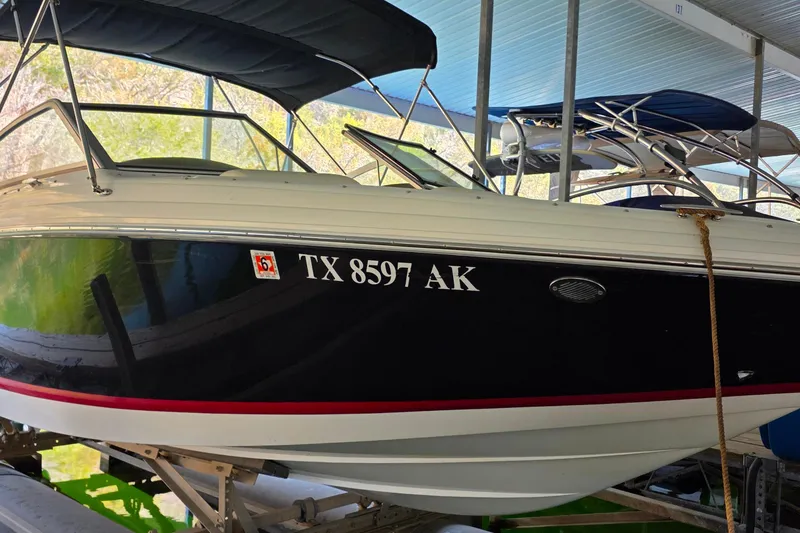 Slide: The Image of 2007 Cobalt 212 boat docked, displaying registration number TX 8597 AK. - 4