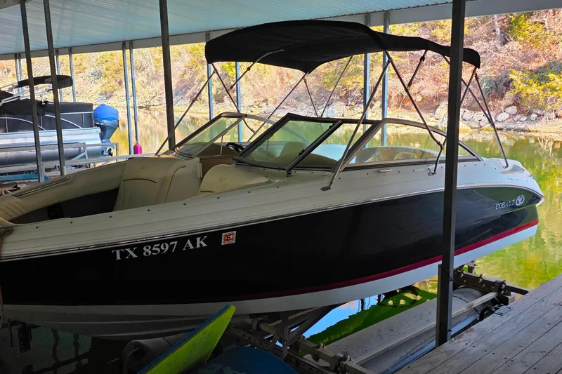 Slide: The Image of 2007 Cobalt 212 boat docked under a covered marina, side view. - 6