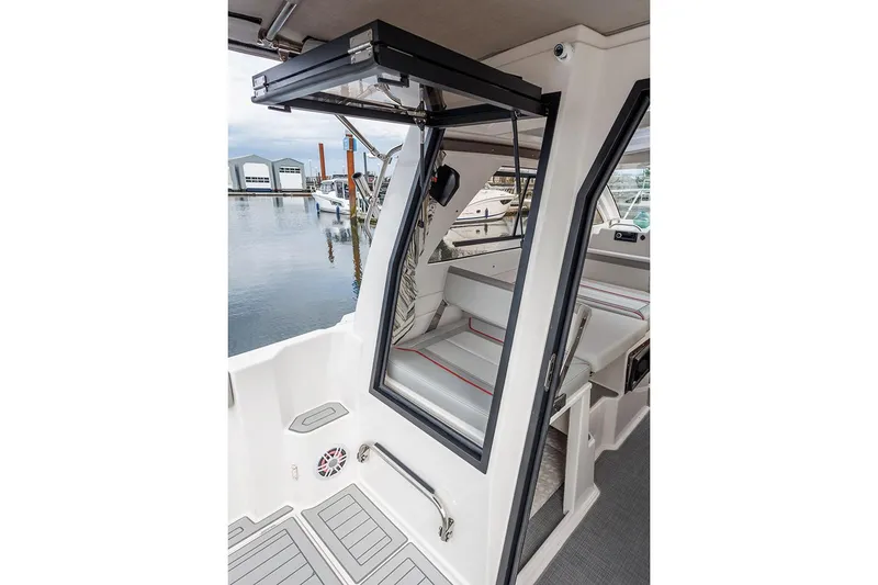 Slide: The Image of Manufacturer Provided Image: 2025 Solara S-250 Coupe boat interior with open door, docked at marina. - 6
