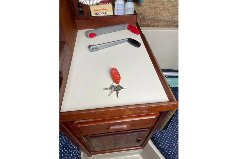 Slide: The Image of Interior of 1982 O'Day 28 sailboat with tools and keys on a counter. - 3