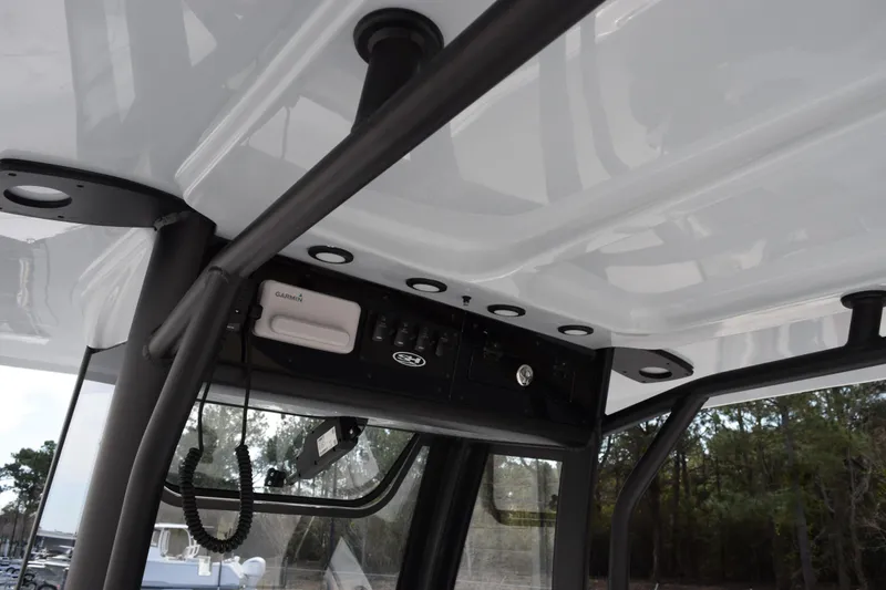 Slide: The Image of 2026 Sea Hunt Ultra 245 SE boat console with Garmin electronics and sturdy framework. - 11