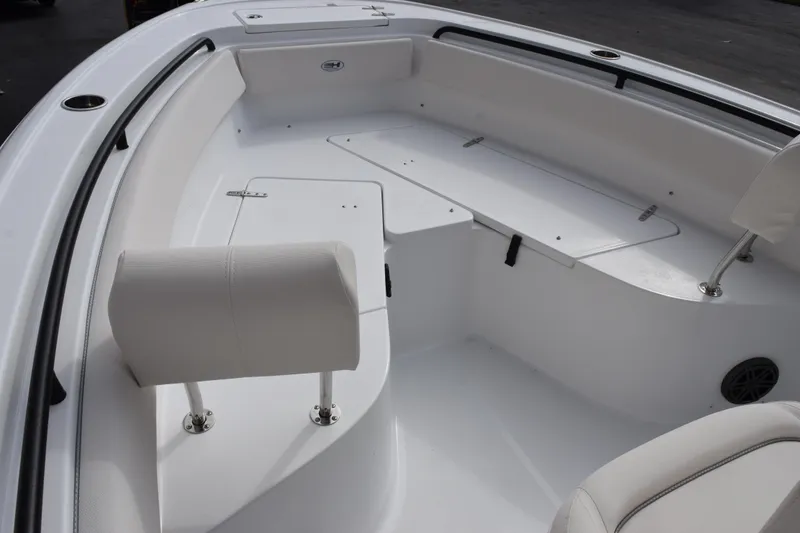 Slide: The Image of 2026 Sea Hunt Ultra 245 SE boat interior with white seating and storage compartments. - 13