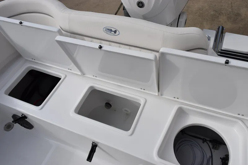 Slide: The Image of 2026 Sea Hunt Ultra 245 SE boat storage compartments and seating area. - 19