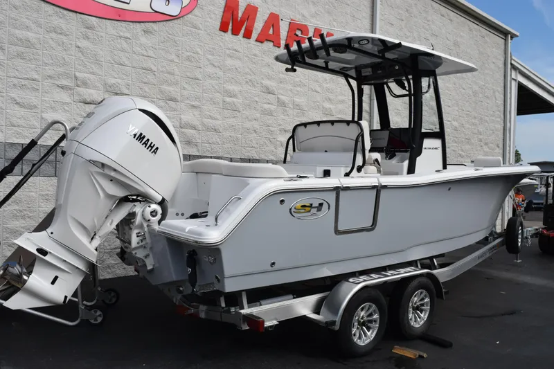 Slide: The Image of 2026 Sea Hunt Ultra 245 SE boat with Yamaha engine on trailer, parked outside. - 4